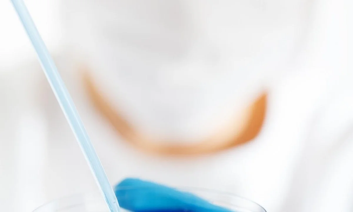 Close-up of a glass with blue liquid and a pale blue straw, representing hydration tools and delivery methods.